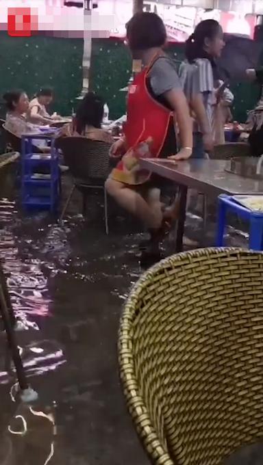 四川暴雨食客积水中淡定吃饭,谈笑风生!网友傻眼:不怕触电吗